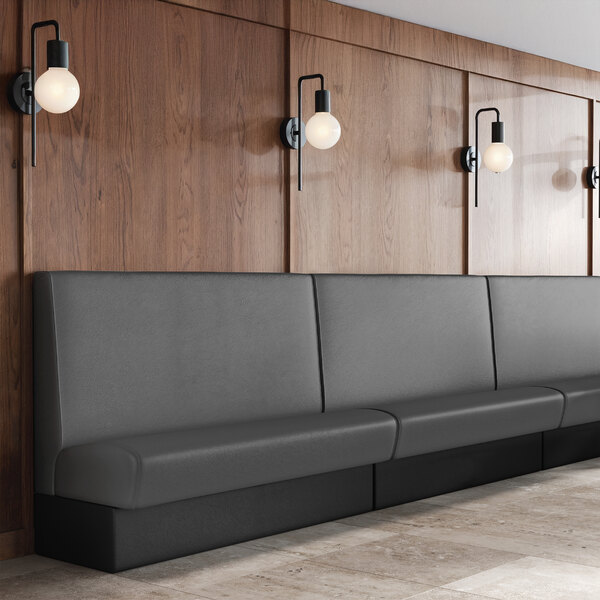 A 30-inch long graphite-colored single back booth with a plain design and a 42-inch high backrest, placed against a wooden paneled wall.