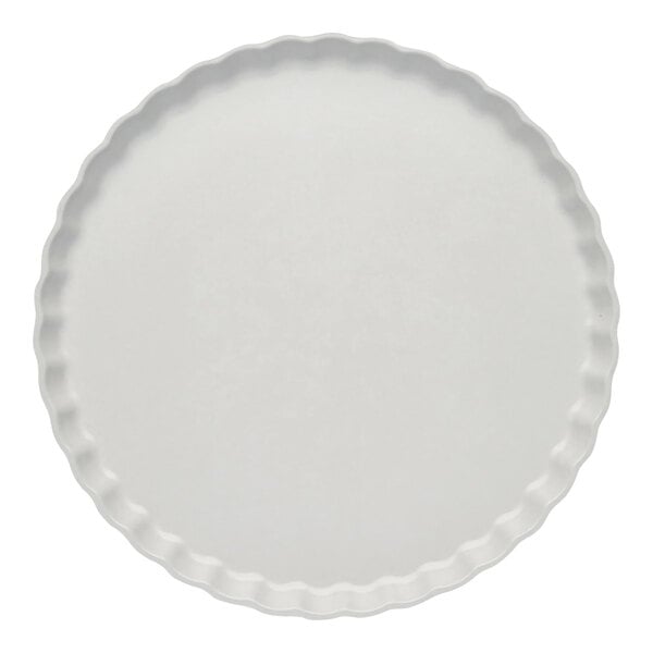 A white Sophistiplate dinner plate with a scalloped edge.