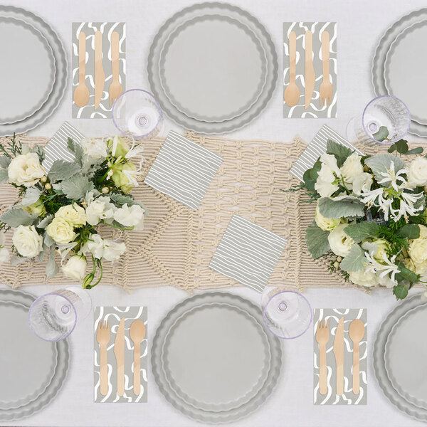 A table set with Sophistiplate Simply Eco Concrete Plant Fiber dinner plates and silverware.