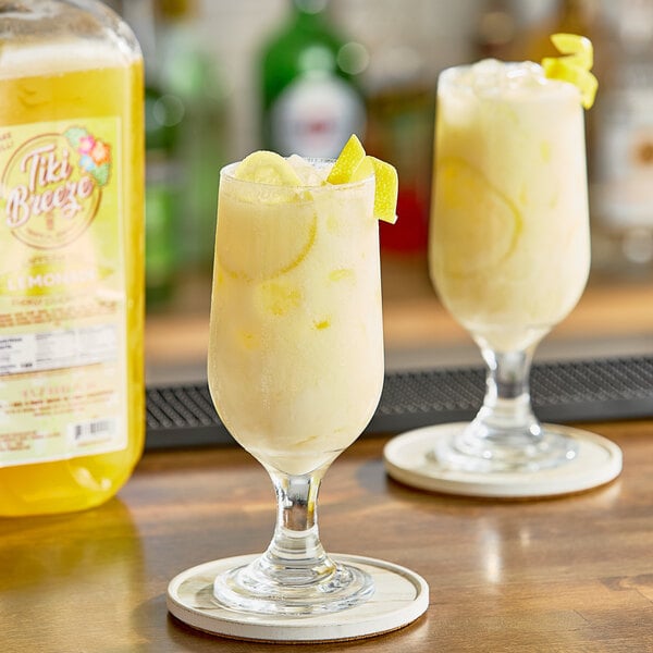 Two glasses of Tiki Breeze Caffeinated Lemonade Energy on a table.
