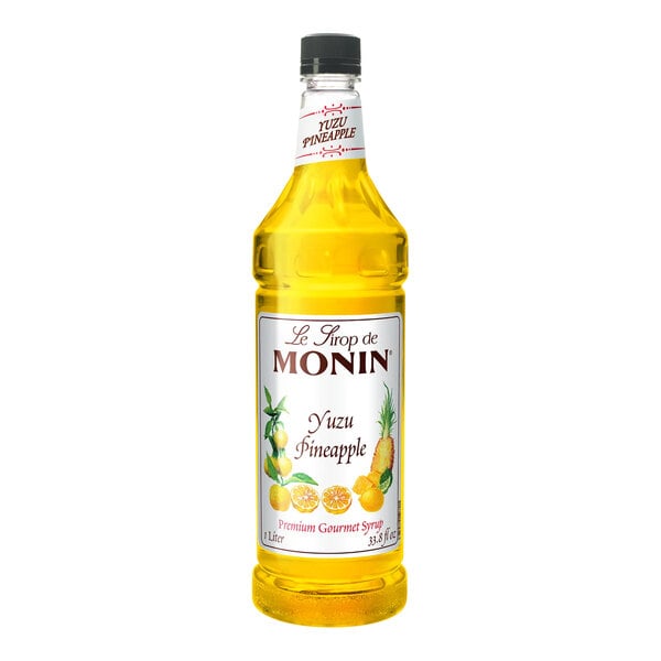 A Monin Premium Pineapple Yuzu flavoring syrup bottle on a white background.