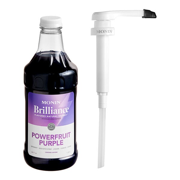 A Monin Brilliance Powerfruit Purple Energy Concentrate bottle next to a white pump.