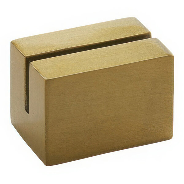 A gold rectangular block with a hole in the middle.