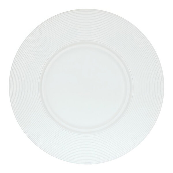 A close up of a white Cal-Mil round melamine plate with a circular design.