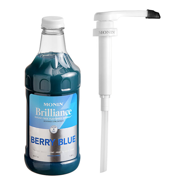A close up of a Monin Brilliance Sugar-Free Berry Blue Energy Concentrate bottle with a white cap next to a pump.