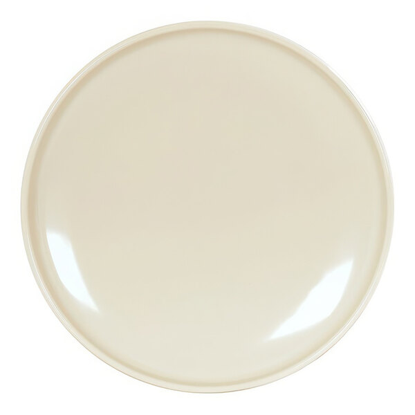 A brown and cream round melamine plate with a white surface and light shining on it.