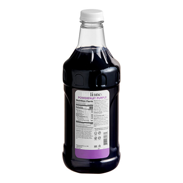 A close-up of a Monin Brilliance Powerfruit Purple Energy Concentrate bottle full of purple liquid.