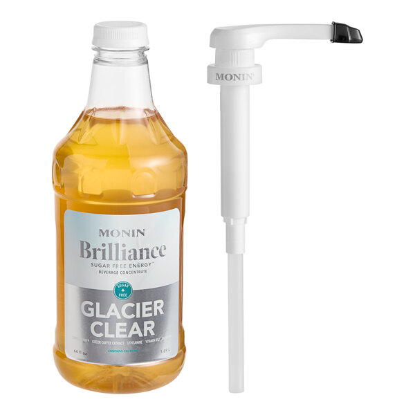 A Monin Brilliance Sugar-Free Glacier Clear Natural Energy concentrate bottle with a white cap and white label next to a pump.