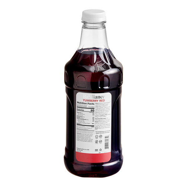 A bottle of Monin Yumberry Red Energy Concentrate with a white cap filled with red liquid.