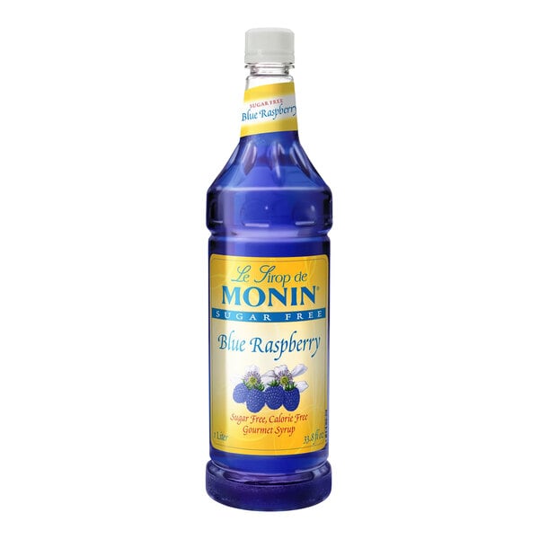 A close up of a Monin blue bottle of sugar-free blue raspberry syrup with a label.