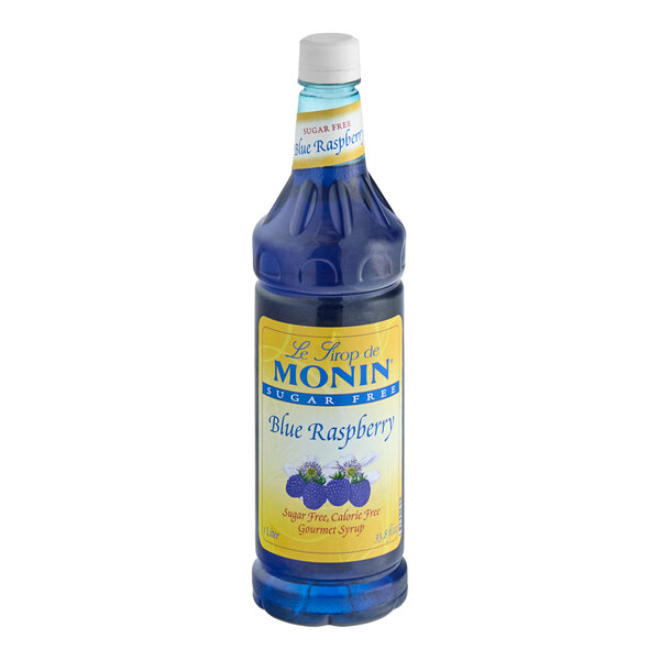 A close up of a Monin Sugar-Free Blue Raspberry syrup bottle with a label.