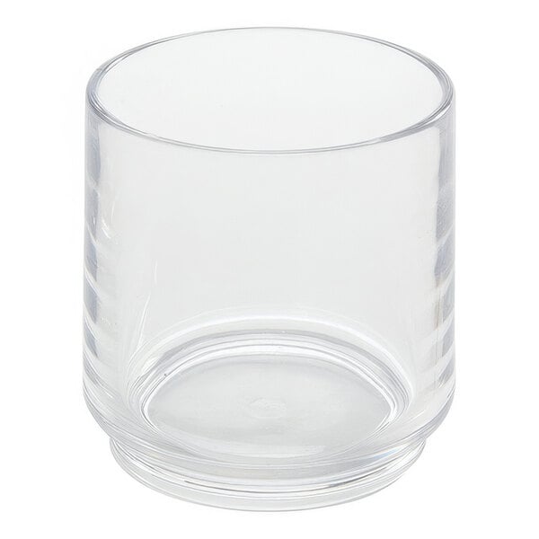 An American Metalcraft Tritan plastic stackable rocks glass filled with a clear beverage on a white background.