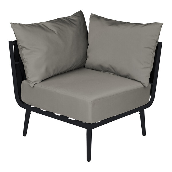 A BFM Seating Cayman outdoor corner chair with a Sunbrella charcoal cushion.