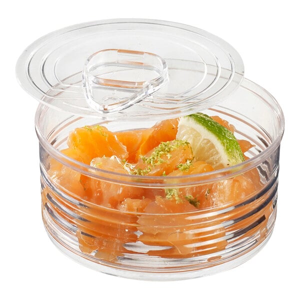 A Solia clear plastic tin can with a lid filled with food.