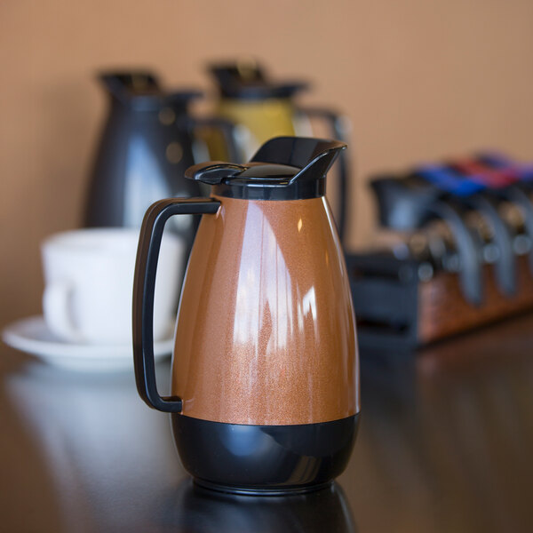 A Service Ideas copper insulated coffee carafe on a table.