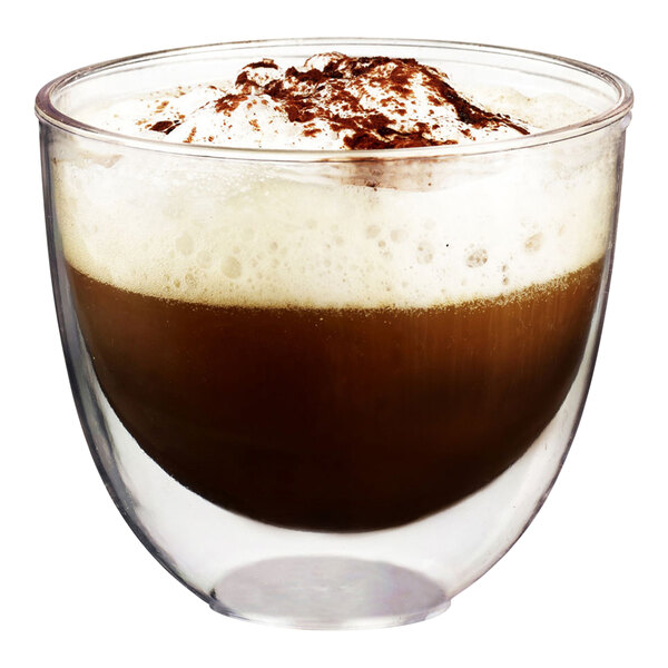 A Solia clear plastic cup filled with a coffee drink topped with whipped cream and chocolate.