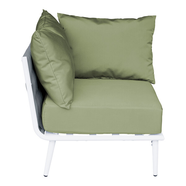 A white BFM Seating outdoor corner chair with a green Sunbrella cushion and 2 back pillows.