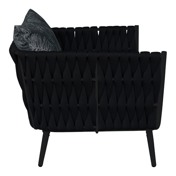 A BFM Seating black outdoor armchair with a black cushion and pillow.