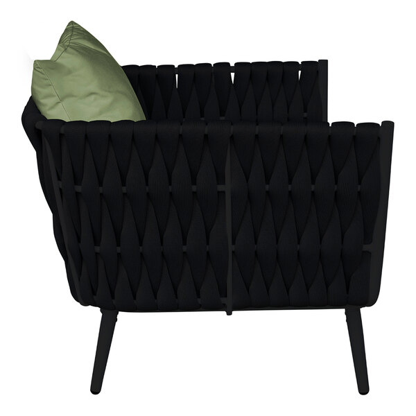 A black BFM Seating outdoor armchair with a green Sunbrella cushion and back pillow.