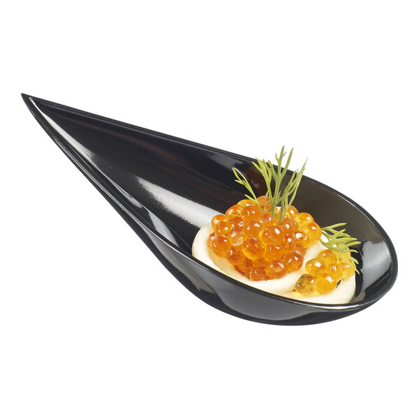 A Solia black plastic tasting spoon with food on it.