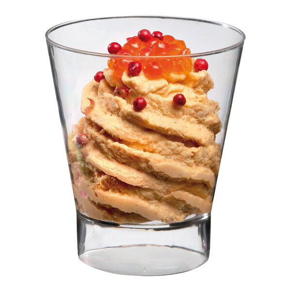 A Solia clear plastic mini cup filled with dessert topped with red berries.