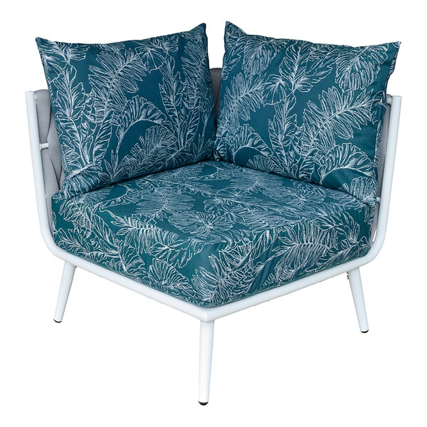 A white BFM Seating outdoor couch corner section with blue and white cushions with a tropical print.