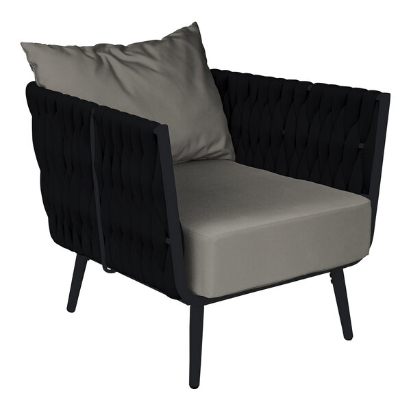 A black BFM Seating outdoor armchair with a Sunbrella charcoal cushion and back pillow.