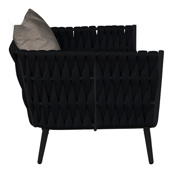 A black BFM Seating outdoor armchair with a Sunbrella charcoal cushion and back pillow.