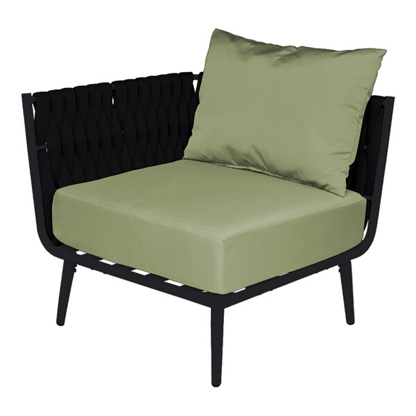 A BFM Seating black outdoor corner chair with a green cushion and 2 pillows.