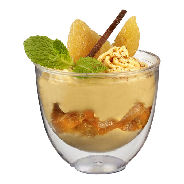 A dessert with ice cream, caramel, and cinnamon in a Solia clear plastic cup.