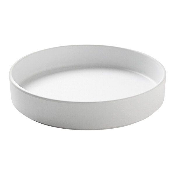 A white round Cal-Mil melamine plate with a raised rim.