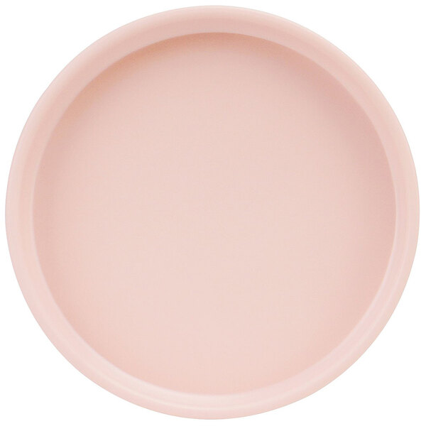 A close-up of a Cal-Mil Hudson blush melamine plate with a low rim.