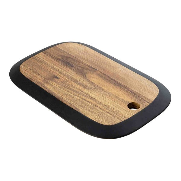 A Tablecraft rectangular acacia wood serving board with a black edge on a table in a deli.