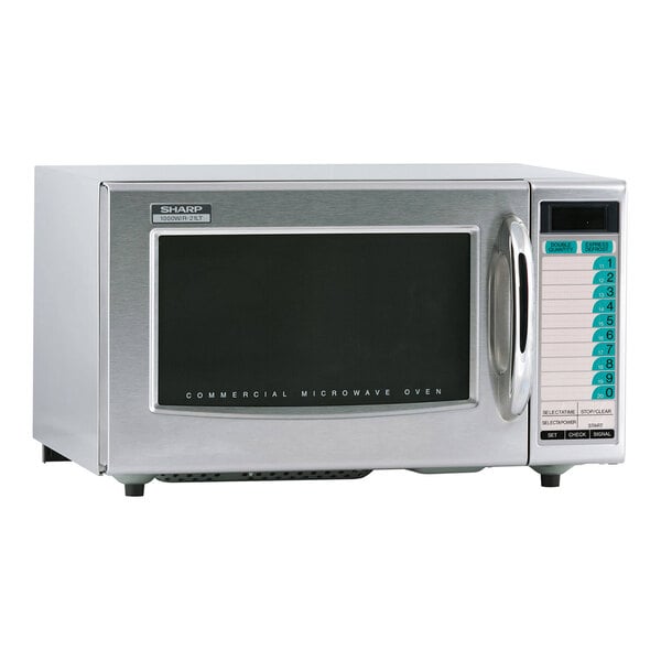 A silver Sharp medium-duty commercial microwave with a black screen and white text.