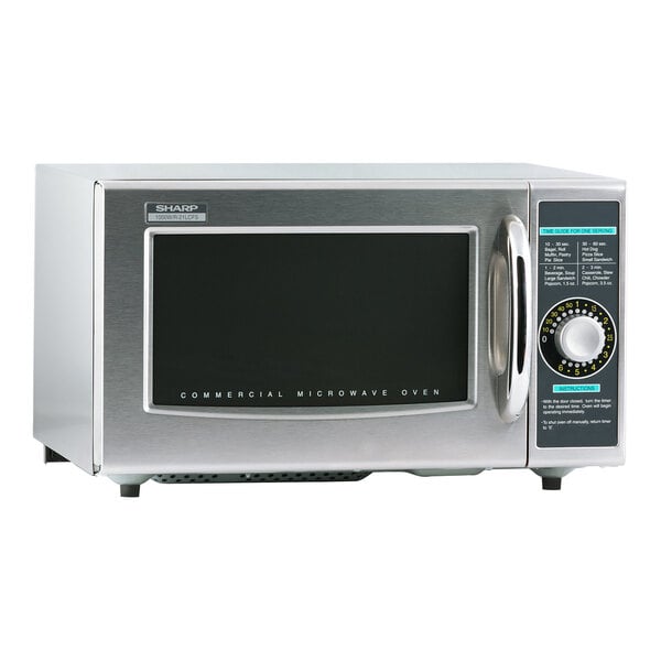 A close-up of a stainless steel Sharp medium-duty commercial microwave with a dial control and black rectangular buttons.