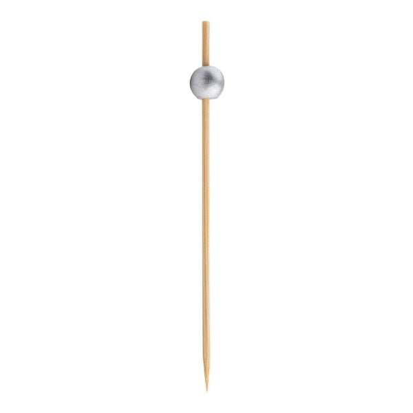 A Tablecraft bamboo food pick with a silver ball on the end.