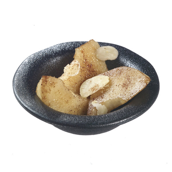 A Solia black porcelain mini dish filled with sliced apples and almonds.