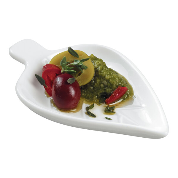 A white Solia porcelain mini dish filled with food on a white surface.