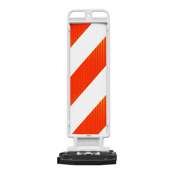A white and orange Plasticade Crosscade parking lot sign with striped prismatic sheeting on a stand.