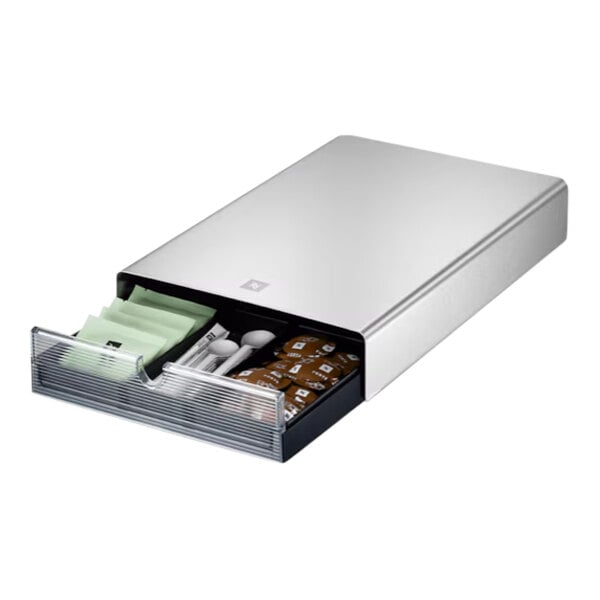 A stainless steel Nespresso capsule drawer with compartments for coffee pods, spoons, and packets.
