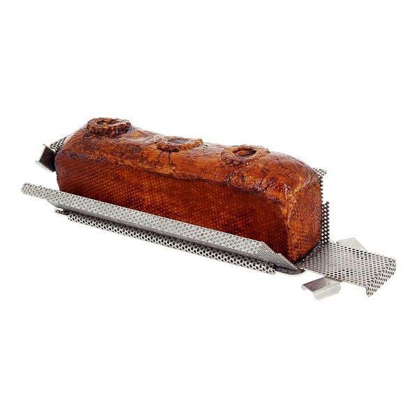 A loaf of bread baked in a de Buyer stainless steel perforated loaf pan.