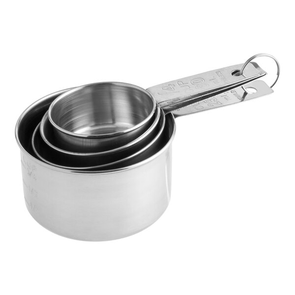 A set of four stainless steel measuring cups nested together with a metal ring.