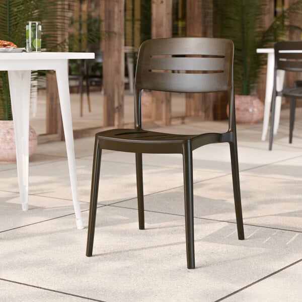 A brown resin side chair with a slat back design.