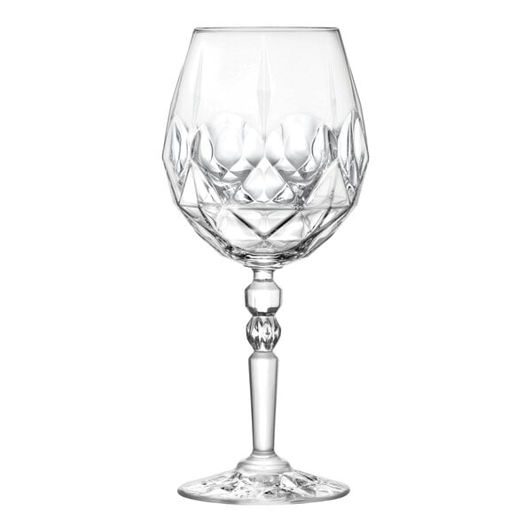 A clear, faceted glass goblet with a decorative stem and base.