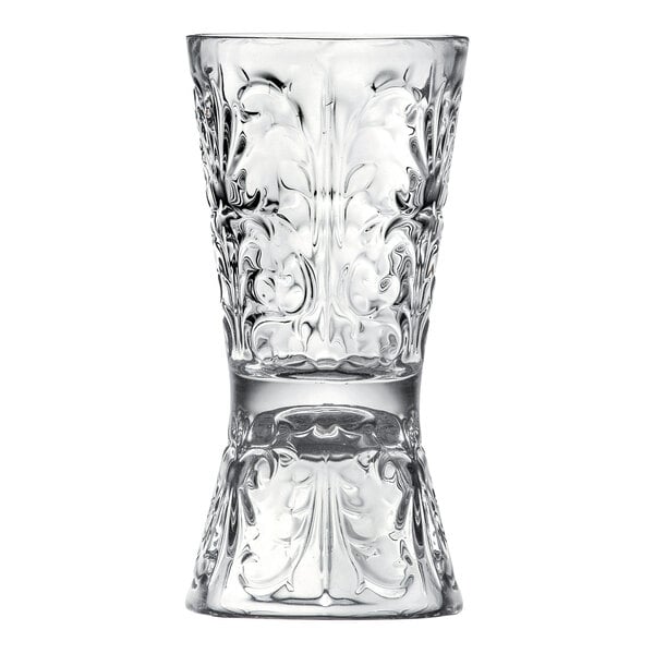 A clear glass Japanese style jigger with ornate embossed detailing, featuring 1 oz. and 2 oz. measuring ends.