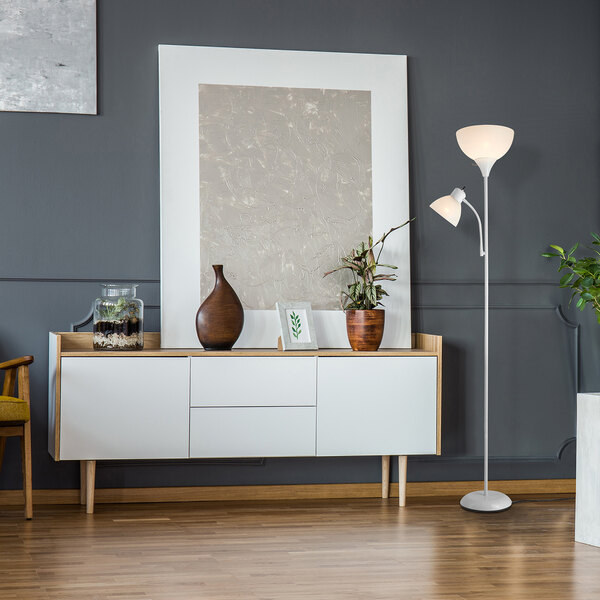 A matte white torchiere floor lamp with an adjustable reading light and frosted plastic shades.