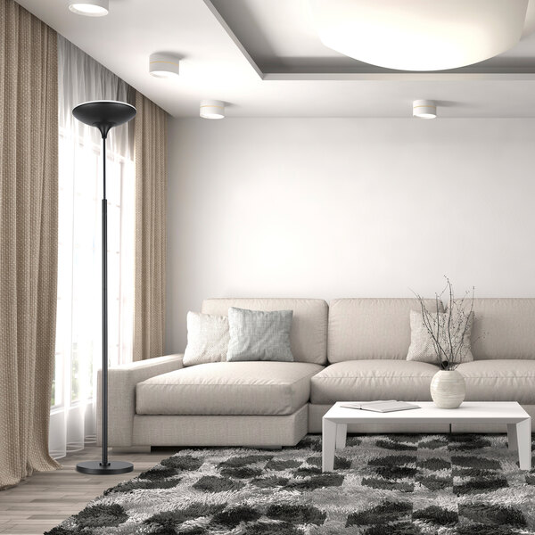 A matte black dimmable LED floor lamp torchiere standing in a modern living room.
