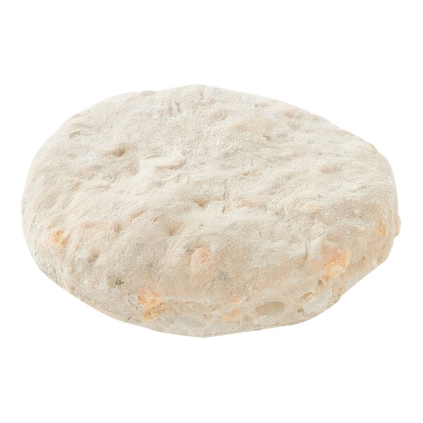 Pillsbury Garlic Cheddar preformed biscuit dough with holes on a white background.
