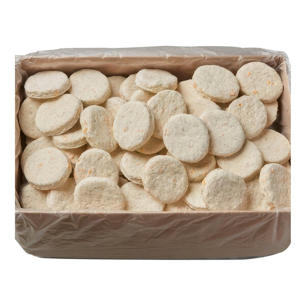 A box of Pillsbury Garlic Cheddar Easy Split preformed biscuit dough, with round white objects inside.