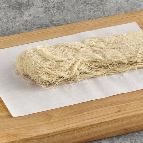 Kontos Kataifi dough noodles on a cutting board.